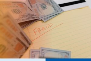 Money and a fraud warning note representing risks of fraudulent payment requests in accounts payable.