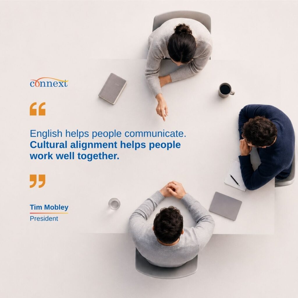 Overhead view of three colleagues seated around a table in discussion, alongside a quote from Tim Mobley, President of Connext.