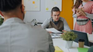 Startup founder reviewing a dedicated outsourced team's dashboard alongside a Connext account manager