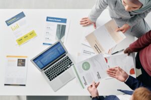 diverse finance team reviewing reports on laptop