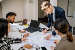 Finance team comparing AI payroll software output with a human payroll specialist's review