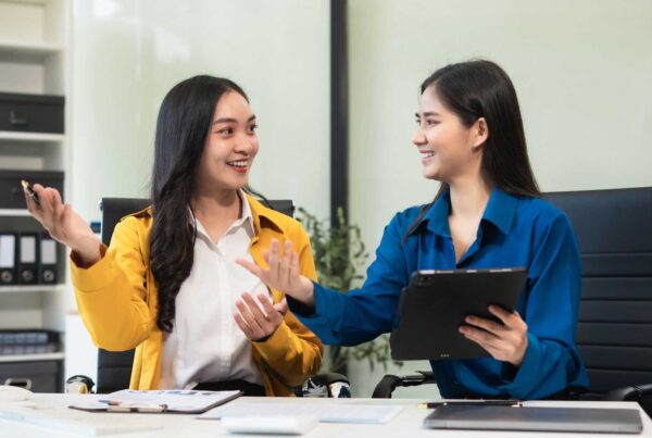 Two women discussing business in an office.