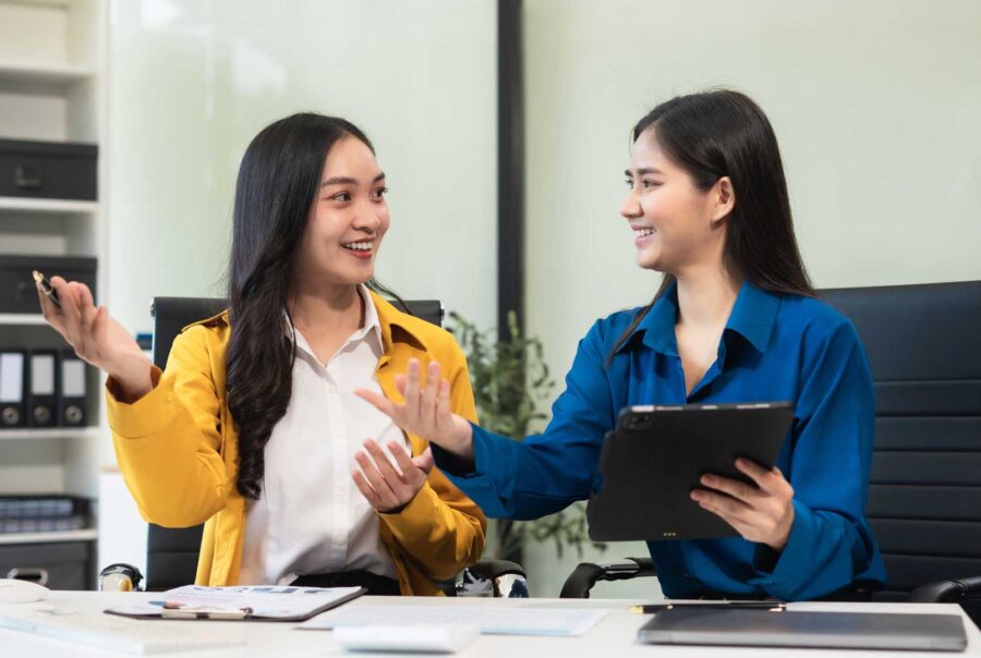 Two women discussing business in an office.
