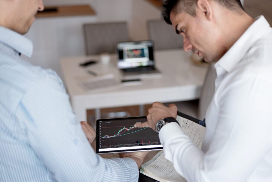 Operating partner reviewing a monthly EBITDA bridge that tracks offshore team savings, transition costs, and attrition